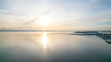 drone aerial view on Snowy cold winter day in Helsinki Finland on a sunny day in the sea side, sea covered with ice