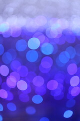 Bokeh, Festive abstract Christmas texture, purple bokeh particles and highlights on dark background.