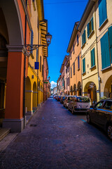 Fototapeta premium A view up the street leading away from the old medieval fortification controlling entry to Castel San Pietro Terme, Italy in summertime