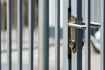 Metal fence with lock that opens with triangular key