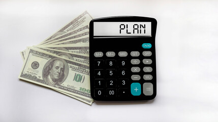 Calculator with word PLAN on dollars - Business management concept