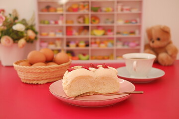 Strawberry cheese cake on red table.