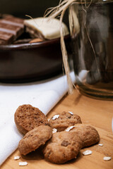 Chocolate chip cookies, dark and white chocolate bar, small bowl of oatmeal and nuts. International Chocolate Day.