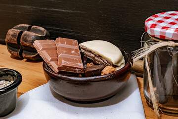 Chocolate chip cookies, dark and white chocolate bar, small bowl of oatmeal and nuts. International Chocolate Day.