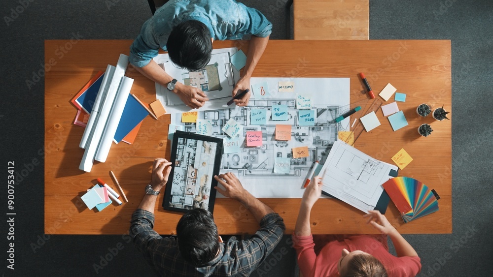 Poster group of people looking at blueprint while brainstorming idea. top view of engineer team looking and