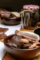 Chocolate chip cookies, dark and white chocolate bar, small bowl of oatmeal and nuts. International Chocolate Day.