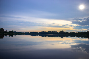 Calm and beautiful silent moment at the lake shore. Sunset during golden