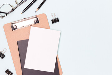 School supplies and eyeglasses on a blue background. Place for text.