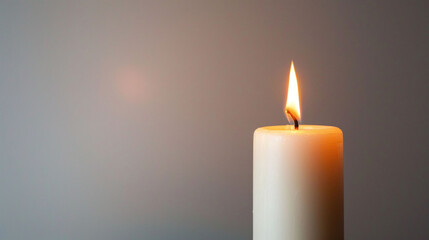 peaceful burning candle flame of fortitude on stark white background photo
