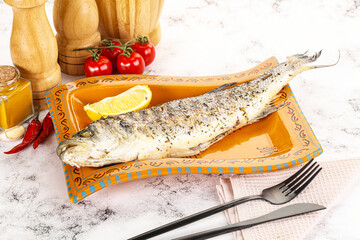 Grilled sea bass fish served lemon