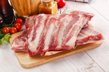 Raw pork ribs over board