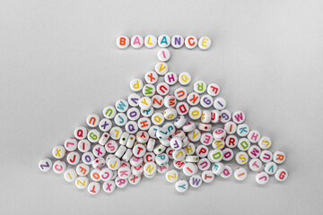 Balance Concept with Colorful Alphabet Beads