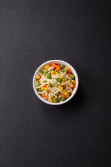 Delicious boiled rice with vegetables or risotto with carrots, peas and corn