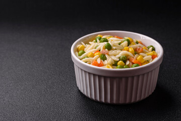 Delicious boiled rice with vegetables or risotto with carrots, peas and corn