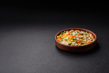 Delicious boiled rice with vegetables or risotto with carrots, peas and corn