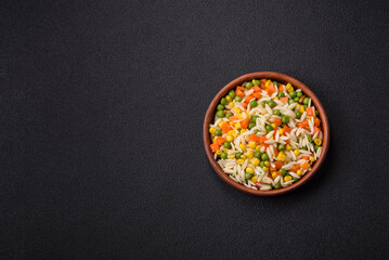 Delicious boiled rice with vegetables or risotto with carrots, peas and corn