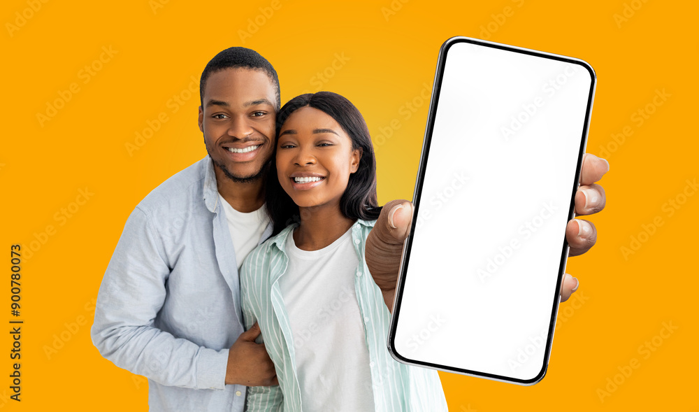 Poster a smiling black couple holding a smartphone with a white blank screen in front of them against a bri