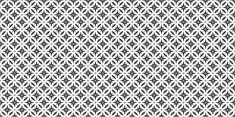 Black and white geometric tile pattern with brown accents, perfect for modern home decor. 
