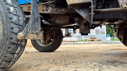 Detailed View Of A Heavy-Duty Truck Underbody During Construction Work On A Sunny Day