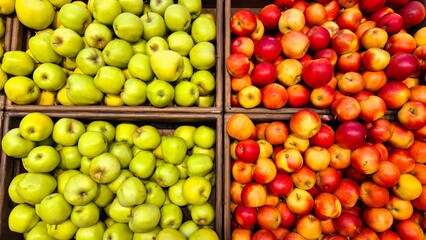Vibrantly Colored Apples and Green Apples Displayed in Wooden Baskets at a Farmers Market