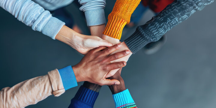 Team of people joining hands showing unity and teamwork
