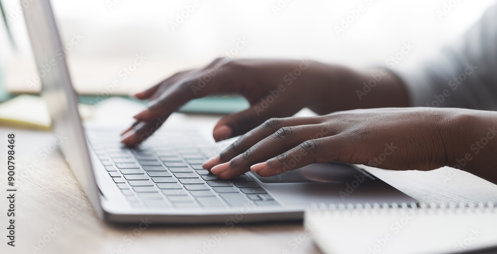 Poster closeup of unrecognizable afro woman typing on laptop keyboard while working in office, panorama
