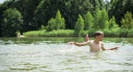 Children swim and play in the lake