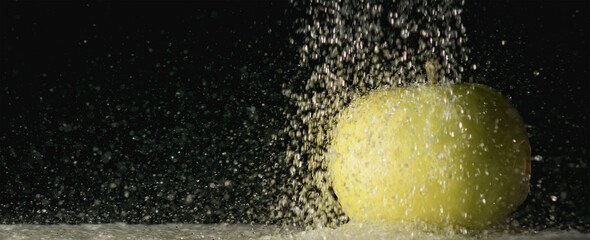 Splashes of water pouring from a hose in the dark