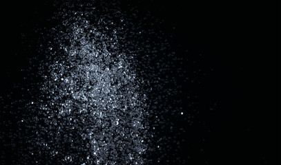 Splashes of water pouring from a hose in the dark