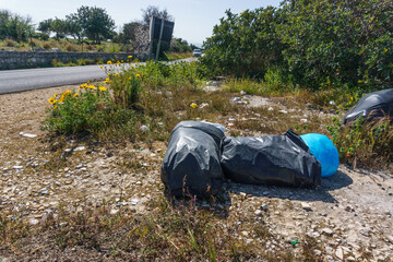 Waste of plastic bags dumped at roadside in Sicily, Italy