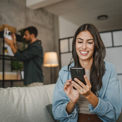 Wife navigate with cellphone her husband how to set cctv camera