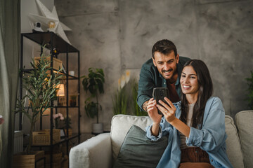 Wife show on cellphone to husband how work cctv surveillance camera