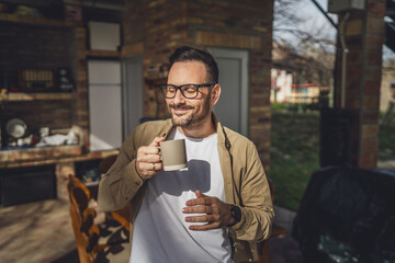 One man stand at his house in sunny day or morning enjoy cup of coffee