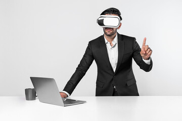 Smart businessman standing at table with laptop while choosing data analysis by using technology innovation. Skilled caucasian project manager using virtual reality glasses and VR goggles. Deviation.