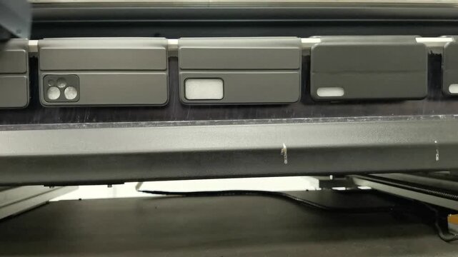 A modern digital large-format UV printer prints images on smartphone cases. UV pinning is the process of applying a dose of low intensity ultraviolet light to a UV curable ink