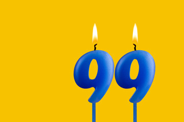 Blue candle number 99 - Birthday on yellow background