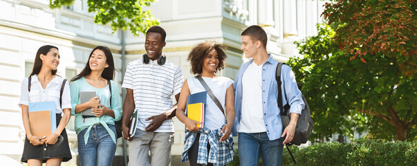 Students communication. Group of college friends walking outdoors in university campus, resting...