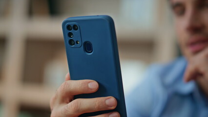 Smiling man playing cellphone at morning apartment close up. Happy businessman
