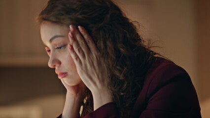 Fototapeta premium Tired writer thinking ideas sitting dark office close up. Fatigued businesswoman