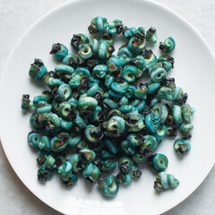 Overhead view of shelled periwinkles on a white plate, top view of fresh cleaned periwinkles,...