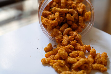 Deep fried macaroni flavored with salt and various spicy herbs native to South East Asia in jar. This enticing food is great for snacking, homemade food.