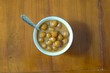Biji salak or bubur candil is Indonesian porridge of sweet potato balls in palm sugar syrup and coconut milk sauce on the table . Very popular during Ramadan.