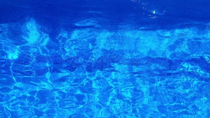 Clean water in the pool. Transparent blue water in a swimming pool background. Cleaning filters for swimming pools. Water filter. Outdoor swimming pool.