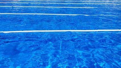 Clean water in the pool. Transparent blue water in a swimming pool background. Cleaning filters for swimming pools. Water filter. Outdoor swimming pool.