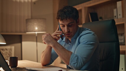 Busy worker calling cellphone working at dark workplace agency close up. 