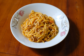 Traditional spaghetti bolognese isolated on wood table background, Culinary. Food background.