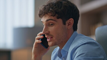 Young professional answering mobile phone call closeup. Busy sales manager talk