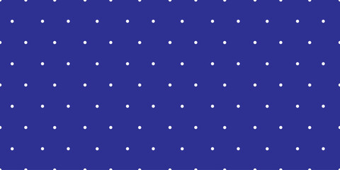 Blue and white seamless polka dot pattern. Uniform white round dots on a blue background. This design is for textile, wallpaper, and digital background.