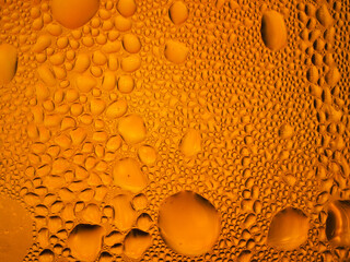 Drops of ice on a golden drinking glass