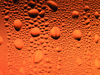 Drops of ice on a golden drinking glass